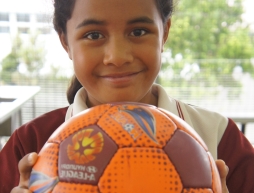 Female student holding soccer ball